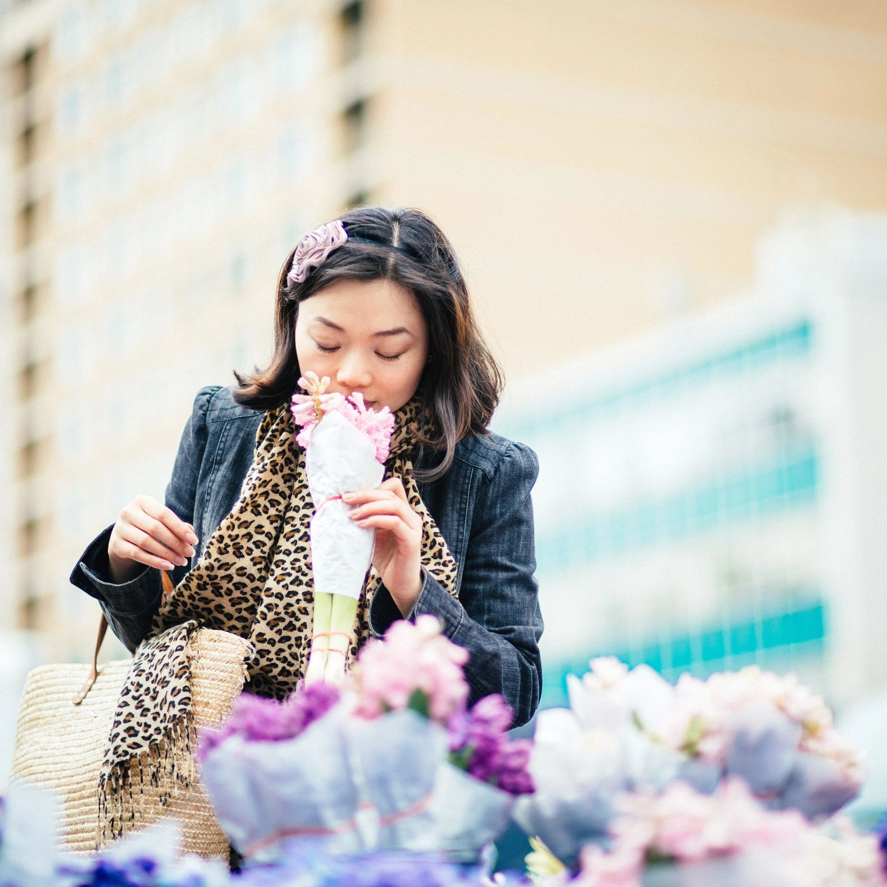 Woman smelling flowers in an urban garden setting
